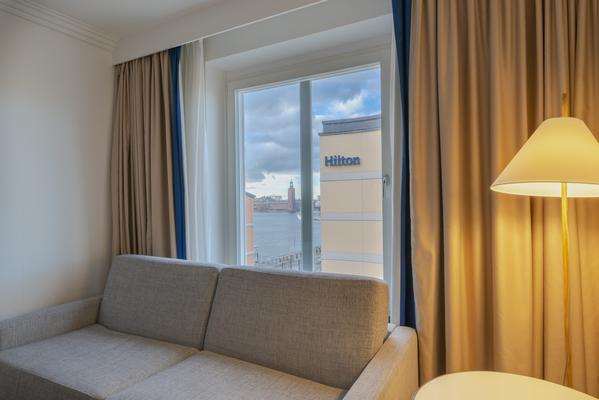 Sitting area of a guest room in Hilton Stockholm Slussen