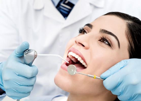 A close-up shot of a patient getting a inspection from a dentist
