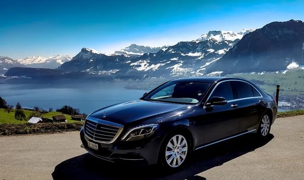 Luxury sedan during limousine service near lake in Switzerland